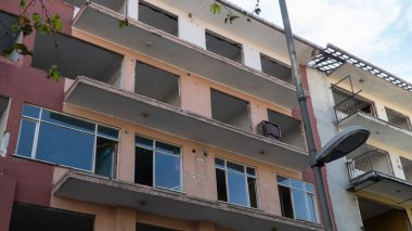 Urban transformation, the process of redevelopment and revitalization of urban areas. Excavators in construction site demolishing old buildings in Golcuk Kocaeli Turkey. Selective focus included.