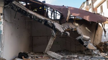 Urban transformation, the process of redevelopment and revitalization of urban areas. Excavators in construction site demolishing old buildings in Golcuk Kocaeli Turkey. Selective focus included.
