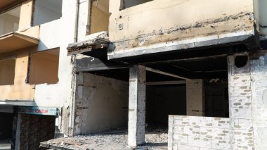 Urban transformation, the process of redevelopment and revitalization of urban areas. Excavators in construction site demolishing old buildings in Golcuk Kocaeli Turkey. Selective focus included.