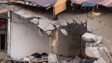 Urban transformation, the process of redevelopment and revitalization of urban areas. Excavators in construction site demolishing old buildings in Golcuk Kocaeli Turkey. Selective focus included.