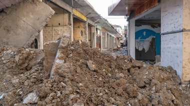 Urban transformation, the process of redevelopment and revitalization of urban areas. Excavators in construction site demolishing old buildings in Golcuk Kocaeli Turkey. Selective focus included.