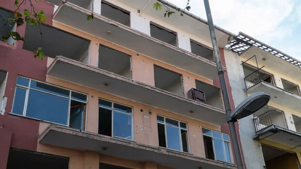 Urban transformation, the process of redevelopment and revitalization of urban areas. Excavators in construction site demolishing old buildings in Golcuk Kocaeli Turkey. Selective focus included.