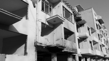 Urban transformation, the process of redevelopment and revitalization of urban areas. Excavators in construction site demolishing old buildings in. Selective focus included