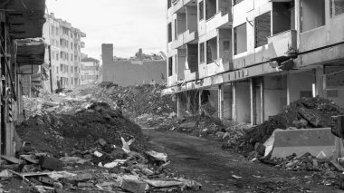 Urban transformation, the process of redevelopment and revitalization of urban areas. Excavators in construction site demolishing old buildings in. Selective focus included