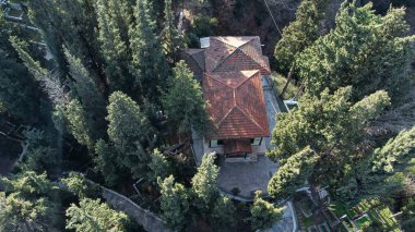 Sultan Baba Tomb in Golcuk Kocaeli Turkey. Aerial view of cemetery with long trees. Selective focus included
