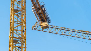 Construction crane at work on a busy building site.