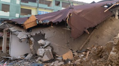 Urban transformation, the process of redevelopment and revitalization of urban areas. Excavators in construction site demolishing old buildings in. Selective focus included