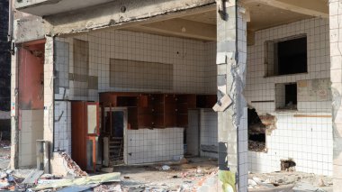 Urban transformation, the process of redevelopment and revitalization of urban areas. Excavators in construction site demolishing old buildings in. Selective focus included