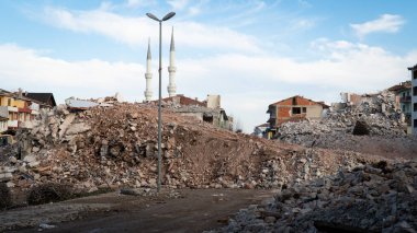 Earthquake damage in a city. Destroyed buildings after an earthquake. Collapsed buildings. Ruined city because of war. Airstrike damages a city. Urban transformation concept. Selective focus included
