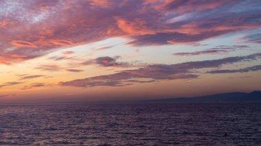 Sunset sky. Cirrocumulus and cirrostratus clouds during sunset. Beautiful dramatic sunset sky background. Selective focus included. Noisy photo