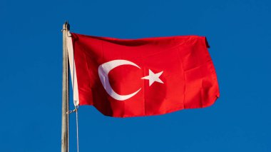 Turkish flag. Turkish flag and dramatic sunset sky. Turkish National holidays concept. 23 Nisan, 19 Mayis, 15 Temmuz, 30 Agustos, 29 Ekim concept. Selective focus. Motion blur due to wind