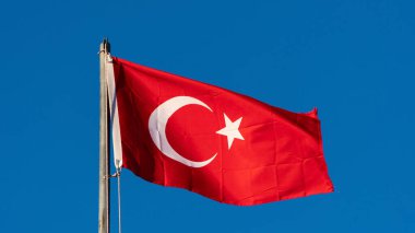 Turkish flag. Turkish flag and dramatic sunset sky. Turkish National holidays concept. 23 Nisan, 19 Mayis, 15 Temmuz, 30 Agustos, 29 Ekim concept. Selective focus. Motion blur due to wind