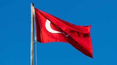 Turkish flag. Turkish flag and dramatic sunset sky. Turkish National holidays concept. 23 Nisan, 19 Mayis, 15 Temmuz, 30 Agustos, 29 Ekim concept. Selective focus. Motion blur due to wind