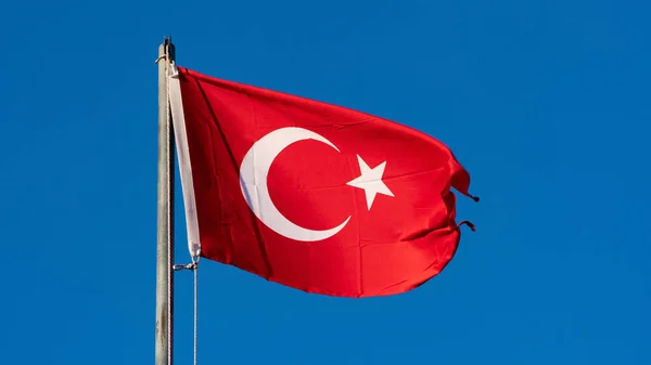 Turkish flag. Turkish flag and dramatic sunset sky. Turkish National holidays concept. 23 Nisan, 19 Mayis, 15 Temmuz, 30 Agustos, 29 Ekim concept. Selective focus. Motion blur due to wind