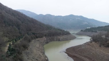 Drought in Turkey. Drought crisis in Turkey. Aerial view of dam with low water level. Yuvacik dam or Kirazdere dam in Kocaeli Turkey. Drone view. Selective focus included. Noisy photo.