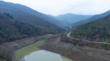 Drought in Turkey. Drought crisis in Turkey. Aerial view of dam with low water level. Yuvacik dam or Kirazdere dam in Kocaeli Turkey. Drone view. Selective focus included. Noisy photo.