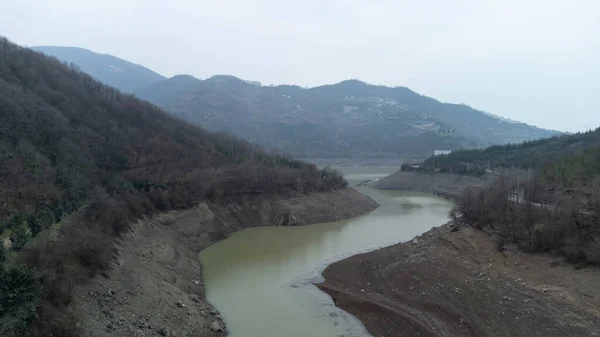 stock image Drought in Turkey. Drought crisis in Turkey. Aerial view of dam with low water level. Yuvacik dam or Kirazdere dam in Kocaeli Turkey. Drone view. Selective focus included. Noisy photo.