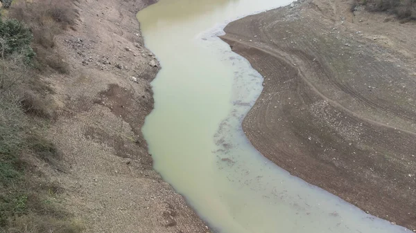 stock image Drought in Turkey. Drought crisis in Turkey. Aerial view of dam with low water level. Yuvacik dam or Kirazdere dam in Kocaeli Turkey. Drone view. Selective focus included. Noisy photo.