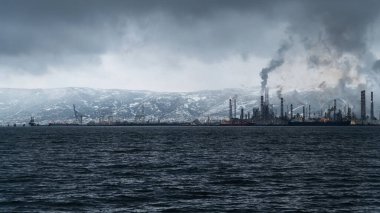 Environmental pollution. Toxic chemical gases releasing to atmosphere from oil refinery plant. Selective focus included. Noise and grain included