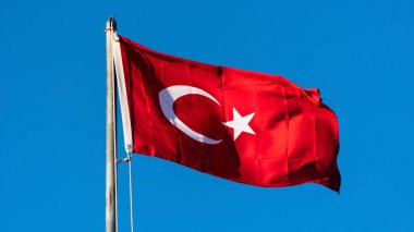 Turkish flag. Turkish flag and dramatic sunset sky. Turkish National holidays concept. 23 Nisan, 19 Mayis, 15 Temmuz, 30 Agustos, 29 Ekim concept. Selective focus. Motion blur due to wind