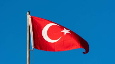 Turkish flag. Turkish flag and dramatic sunset sky. Turkish National holidays concept. 23 Nisan, 19 Mayis, 15 Temmuz, 30 Agustos, 29 Ekim concept. Selective focus. Motion blur due to wind