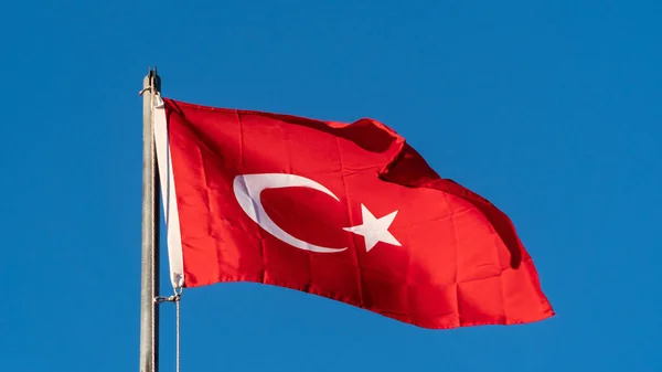 Turkish flag. Turkish flag and dramatic sunset sky. Turkish National holidays concept. 23 Nisan, 19 Mayis, 15 Temmuz, 30 Agustos, 29 Ekim concept. Selective focus. Motion blur due to wind
