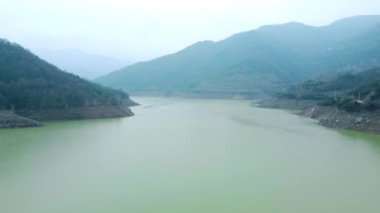 Drought in Turkey. Drought crisis in Turkey. Aerial view of dam with low water level. Yuvacik dam or Kirazdere dam in Kocaeli Turkey. Drone view. Selective focus included. Noisy photo.