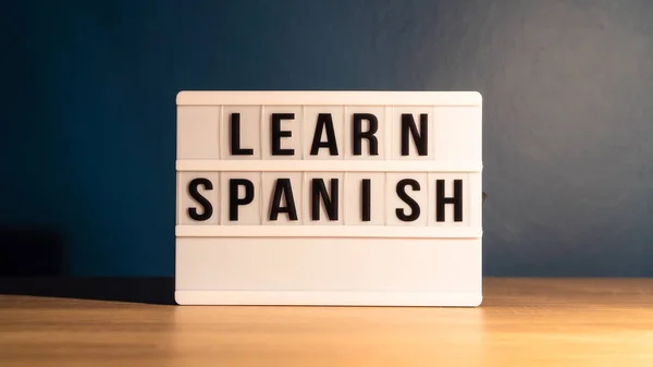 Learning language concept. Learning Spanish word on white letter board. Foreign language course concept.