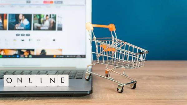Online Shopping Concept Shopping Cart Trolley Laptop Wooden Table — Stock Photo, Image