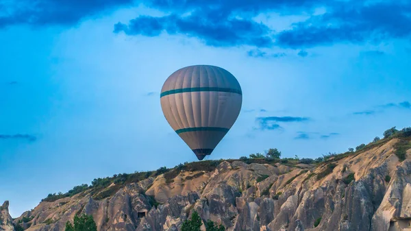 stock image Cappadocia Turkey. Hot air balloons flying over fairy chimneys at sunrise in Cappadocia. Travel to Turkey. Touristic landmarks of Turkiye. Selective focus included