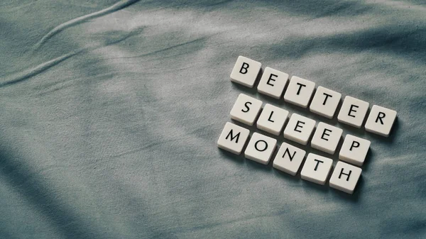 Better sleep month. Better sleep month words on soft bed. High angle view. Selective focus included. Presentation template