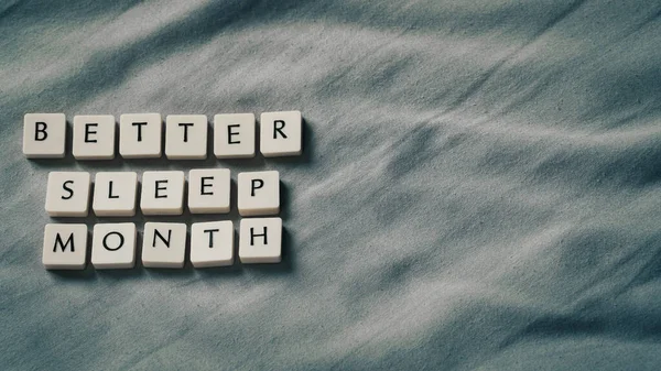 Better sleep month. Better sleep month words on soft bed. High angle view. Selective focus included. Presentation template