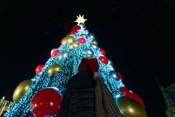 Woman Santa Claus Hat Scarf Looks Beautiful Decorated Christmas Tree — Stock Photo, Image