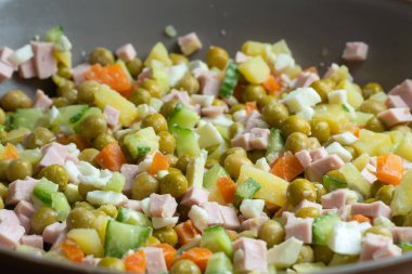 Olivier salatasını mayonezle karıştırmadan önce bir kaseye koy.