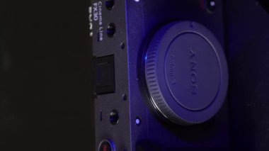 Mogilev, Belarus - January 4, 2023: Sony Alpha fx30 Mirrorless Digital Camera Case. Sony Slow Rotating Camera. Sony alpha camera Rotate camera on table on black background with blue and gray lighting.