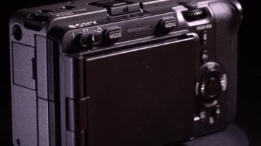 Mogilev, Belarus - January 4, 2023: Sony Alpha fx30 Mirrorless Digital Camera Case. Sony Slow Rotating Camera. Sony alpha camera Rotate camera on table on black background with blue and gray lighting.
