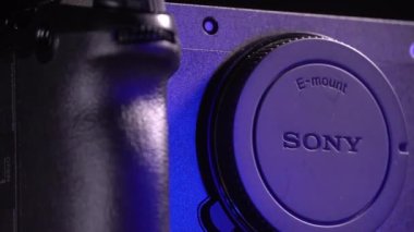 Mogilev, Belarus - January 4, 2023: Sony Alpha fx30 Mirrorless Digital Camera Case. Sony Slow Rotating Camera. Sony alpha camera Rotate camera on table on black background with blue and gray lighting.