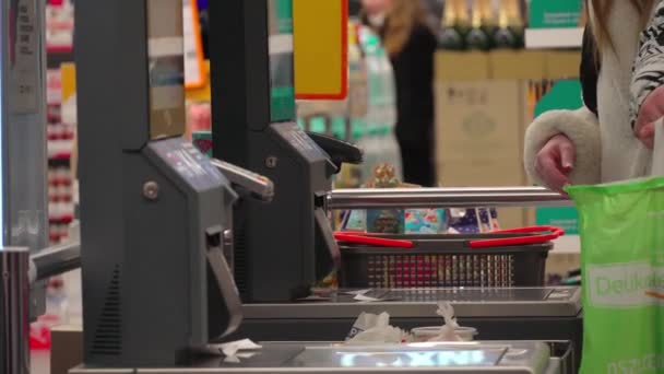 女买主在超级市场使用自助收银员结帐 顾客扫描生产的商品在杂货店使用自助服务收银机 出纳终端妇女在网上支付产品费用 — 图库视频影像