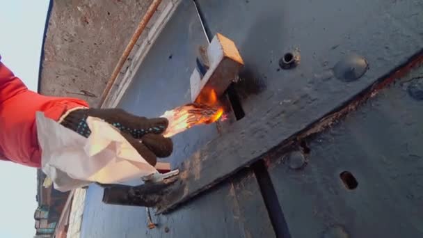 Gloved Man Hand Holds Burning Paper Padlock Iron Garage Door — Video