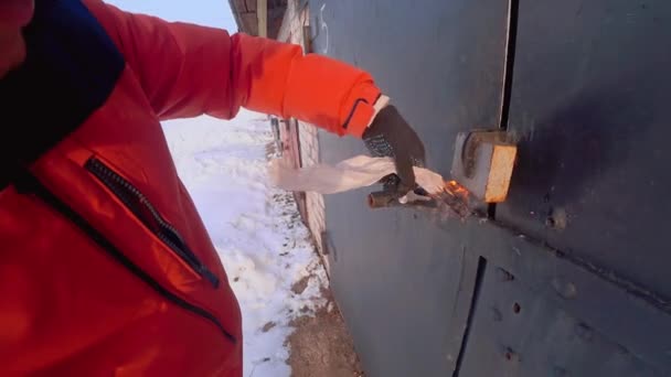 Gloved Man Hand Holds Burning Paper Padlock Iron Garage Door — Vídeos de Stock