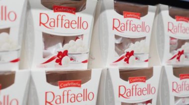 Mogilev, Belarus - May 2, 2022: Italian raffaello sweets on shelf for sale in shopping center grocery supermarket. Shelf in store with boxes of chocolates. Chocolates for Valentine's Day