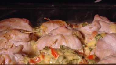 Tasty chicken meat portions in pan. Frying or roasting processing. Preparing food on kitchen stove. Drumstick and chicken legs are fried in slow motion.