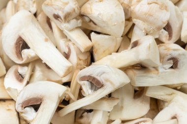 Young champignons, cut into plates. Macro, background