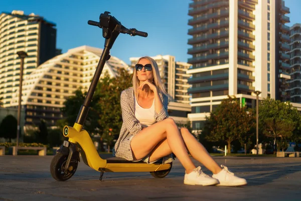 Beautiful Young Slender Blonde Woman Sunglasses Sitting Her Yellow Electric — Stok Foto