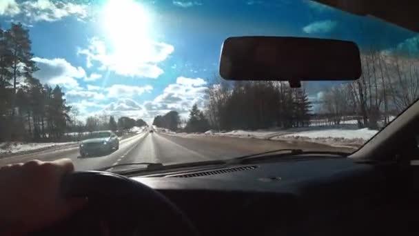 汽车在公路或高速路上行驶的动作摄像 驾驶汽车的人手握方向盘 上路旅行 在阳光明媚的冬季开车 — 图库视频影像