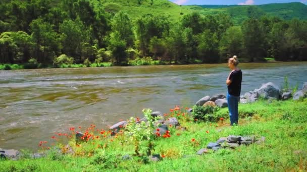 Young Woman Jeans Shirt Stands Mountain River Background Mountains Beautiful — Stock Video