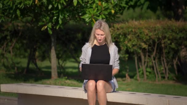 Woman Sitting Park Sunny Day Laptop Working Raises Her Hands — Stock Video