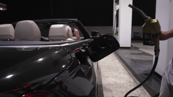 사람은 주유소에서 가솔린을 자동차로 펌프합니다 주유소에서 자동차에 가솔린으로 연료를 채우는 — 비디오