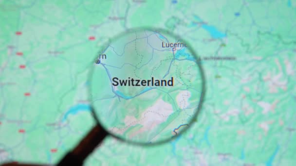 Batumi Georgia 2024年1月11日 瑞士通过谷歌地球屏幕上的放大镜 电脑屏幕上的数字地图上的放大玻璃 — 图库视频影像