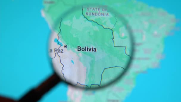 Batumi Georgia 2024年1月11日 玻利维亚通过谷歌地球屏幕上的放大镜 电脑屏幕上的数字地图上的放大玻璃 — 图库视频影像